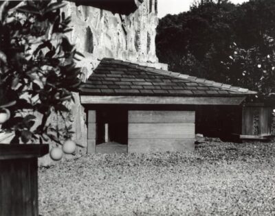 Black and white photograph of the doghouse with two sides of the roof very steeply pitched.