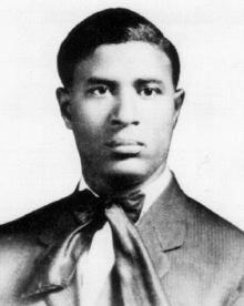 A black-and-white photo of a young Garrett Morgan. He is dressed up for the photograph with a bow tie and jacket.
