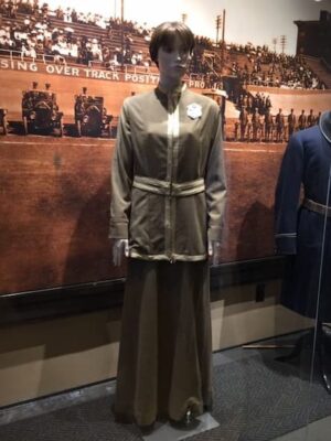 This is a photograph of the type of uniform that Alice Wells made for herself. The skirt is long and the jacked appears to be belted. Her badge is also on the uniform.