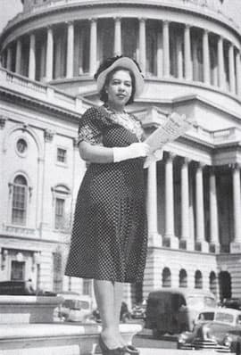 White House reporter Alice Dunnigan standing on the Capitol steps.