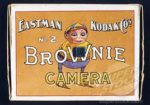 A color ad from Eastman Kodak featuring a Palmer Cox brownie holding a Brownie camera.
