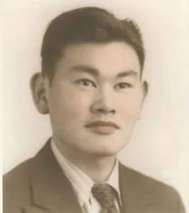 A copy of a portrait of Fred Korematsu as a young man. He is dressed in a suit and tie.