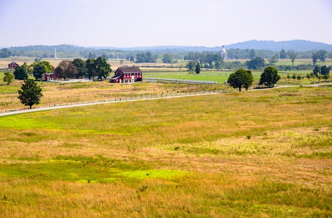 Green field at Gettysburg with historic house in background