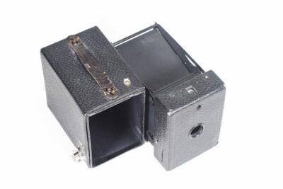 This shows the box camera taken apart. the right side shows where the film was held and how it oculd be wound. the left side shows the box that held the camera.