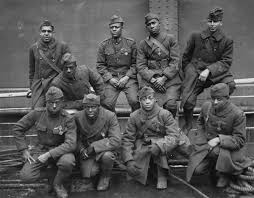 Nine Harlem Hellfighters posing for a photograph.