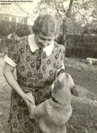 An older Helen Keller with her Akita. 