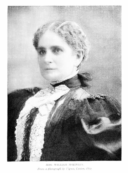 In this portrait photograph, Ida McKinley is fetchingly dresssed with a high-collared dress and a white frontspiece. Her sleeves are balloon-style sleeves. Library of Congress.