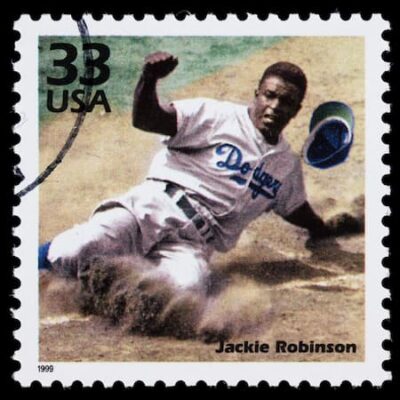 Jackie Robinson image on US stamp. He is sliding into home base. istock