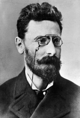 Black and white photo of Joseph Pulitzer with a beard and wearing pince-nez glasses