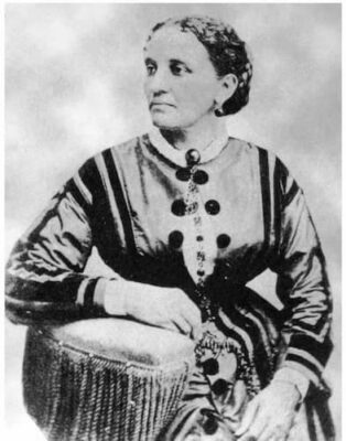A photograph of Keckly, likley for her book. She is dressed beautifully, her hair is pulled up in a snood, andshe wears gold hoop earrings.