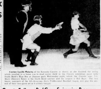 This was newspaper coverage of the Kenosha Comets and the South Bend Belles. Lucille Calacita of the Comets is catching while a Belle makes a strong hit. An umpire stands behind the plate.