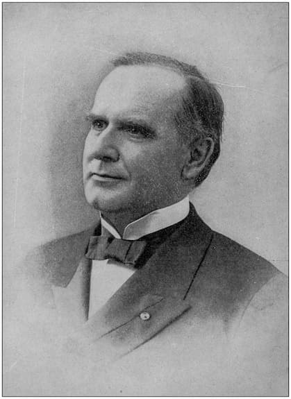 A professional black-and-white portrait photo of William McKinley. He is dressed in a suit with a flat-appearing bowtie.