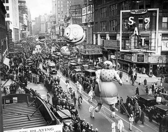 This is a black-and-white photo of a long view of the Macy's parade. Mrs. Katzenjammer, a popular cartoon character of the 1930s, is at the forefront.