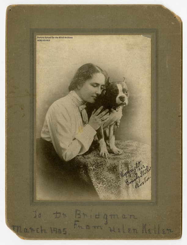 Helen Keller when she was in college with her dog, Phiz.