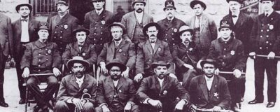 After the U.S. Mashals disbanded, Reeves joined the Muskogee Police Force. This is their progressional photo. Several are in classic police uniforms with hats and billy clubs. A few of them--including Reeves--are dressed for undercover work.