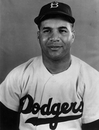 Roy Campanella, catcher for the Brooklyn Dodgers, sitting next to Jackie  Robinson in the dugout during a baseball game] / Eide.