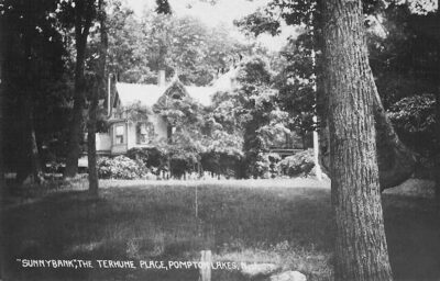 a view through the trees of the Sunnybank house. The photo is black and white but Wisteria would have grown everywhere.