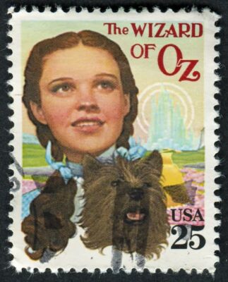 A 25-cent U.S. postage stamp showing a color photo of Dorothy and Toto from The Wizard of Oz.