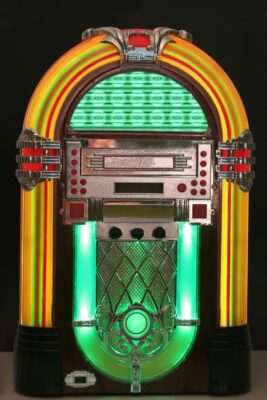 A colorfully designed jukebox with lights and tubes..