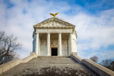 Staircase going up to mausoleum/monument with an eagle on the peak of the roof