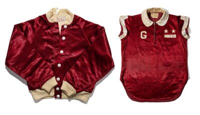 The Gravey Stars uniform appears to be made of a red velvet material, The jacket is like most sports team jackets wiht white cuffs and white binding around the waist. Villa's shirt is also of the red material but sleeveless. It has a G on it and 2 stars.,