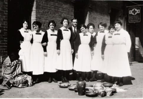 The photos show the women lined up for the photo with a sampling of Native American dishes on display in front of them.