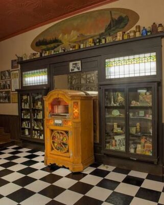 This is a color photograph of a jukebox in an Art Deco room. 