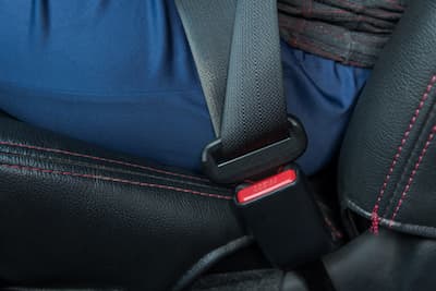 adult using seat belt; car safety