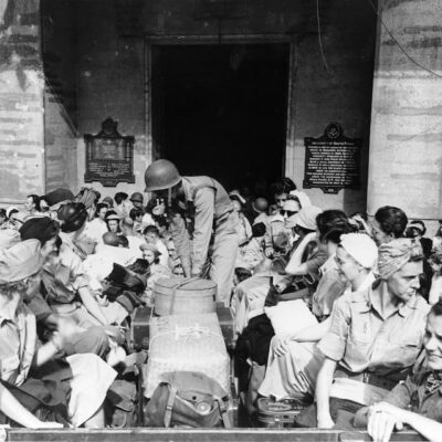 Army nurses at rescue. Chaotic scene as they prepare to leave