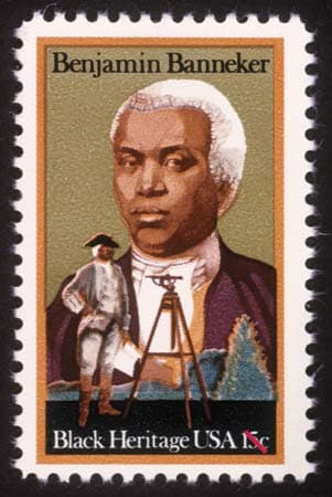 U.S. postage stamp featuring Banneker with white hair, wearing a brown coat, and depicted as a historical figure by a surveying instrument. Text: Benjamin Banneker and Black Heritage USA 15c.