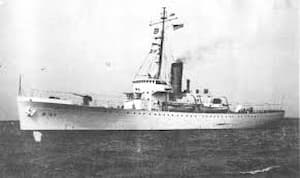 This is a black-and-white photograph of the Coast Guard cutter, The Comanche. The photo was taken with the cutter on the ocean and its flags flying