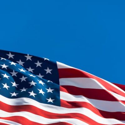 The US flag waving in a blue sky