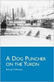 The book cover of "A Dog Puncher on the Yukon," the photograph shows a camp site with several dogs harnessed to a sled, ready to go.