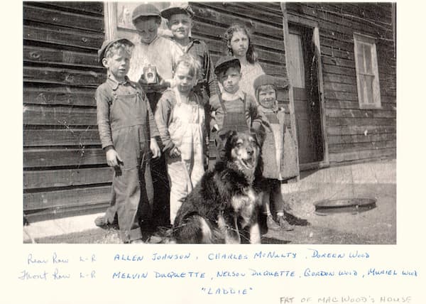 the photo of seven children with a camera might date to the 1930s. They are having their photo taken. 