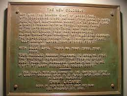 A photograph of the poem, "The New Colossus" on a brass plaque.