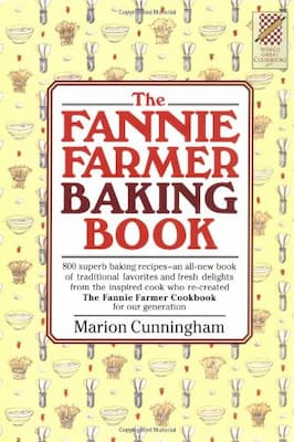 A photograph of a modern copy of The Fannie Farmer Baking Book by Marion Cunningham.