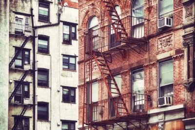 A red brick building with a traditional exterior fire escape.