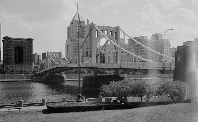 A black-and-white photo of the Roberto Clemente bridge in Pittsburgh.