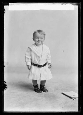 A little boy in period clothing identified as "Harrison Child."