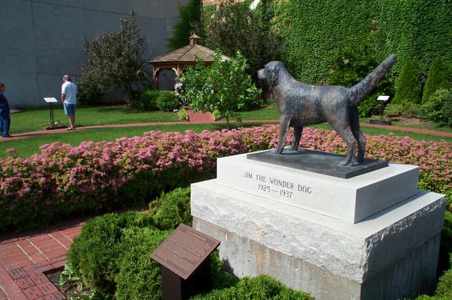 A color photograph of the memorial park with the statue of Jim to the right.