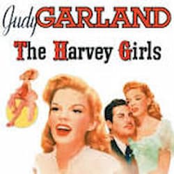 This is a color movie poster with several illustrations of Judy Garland in different costumes for the movie/