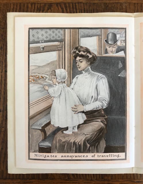 This is an illustration of a well-dressed mother with a Gibson hairdo. She is holding a toddler, dressed in white, so that the baby can stand on her lap and watch the passing scenery as the train continues.