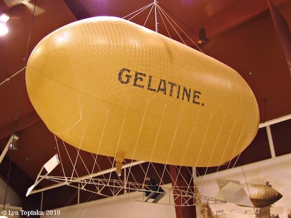 A large hot yellow hot air balloon with "Gelatine" written on the side. The airship flew at the Lewis and Clark Exposition.