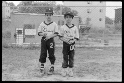 A black-and-white photo of two Latino boys who participated in a sports clinic made possible by Clemente