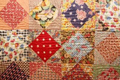 This a beautiful patchwork quilt likely using pieces of old clothing to provide the variety. istock JTGrafix