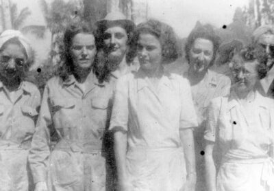 About seven of the nurses can be seen in this casual photograph. They are in nursing uniforms.